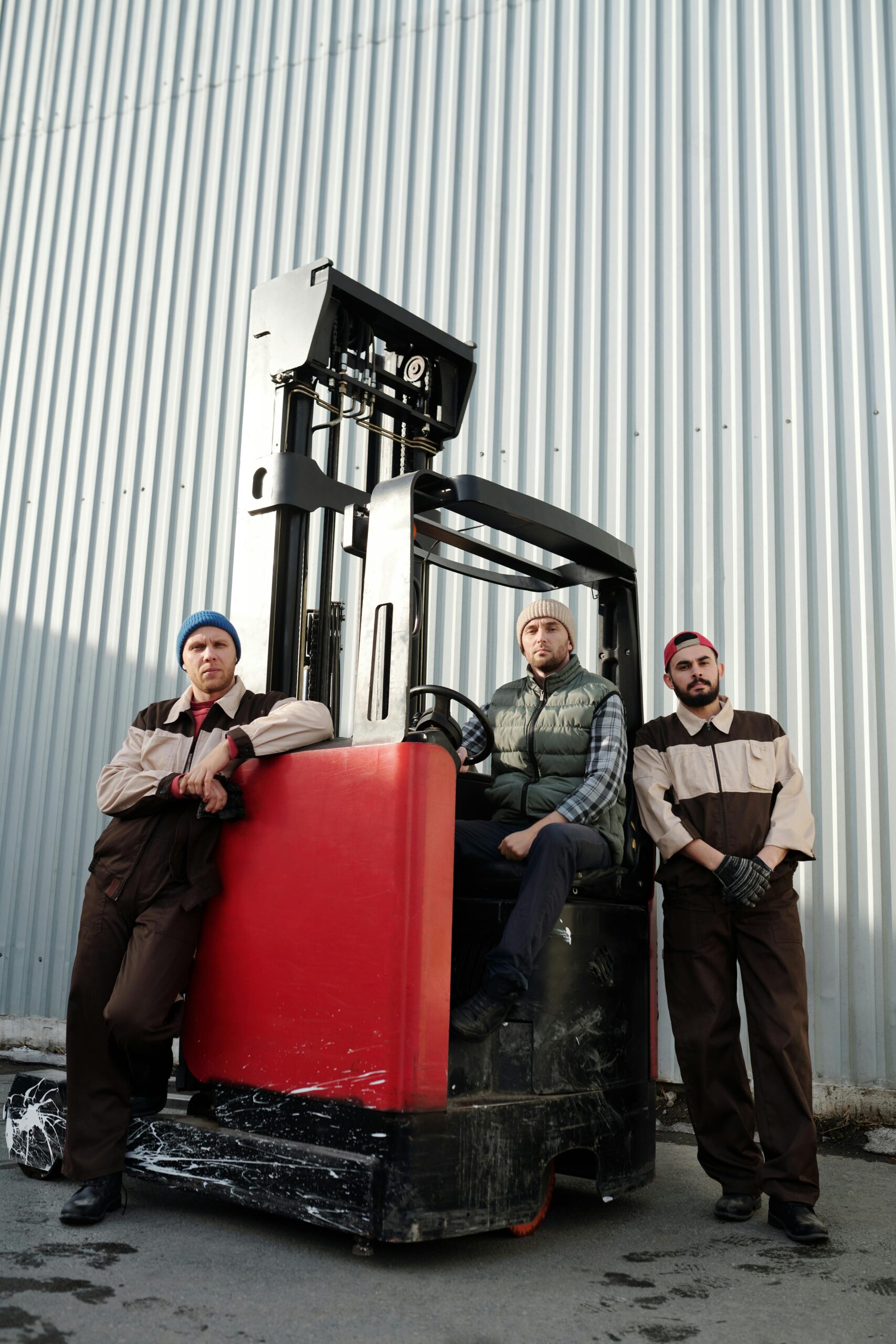 Employees Standing beside Forklift